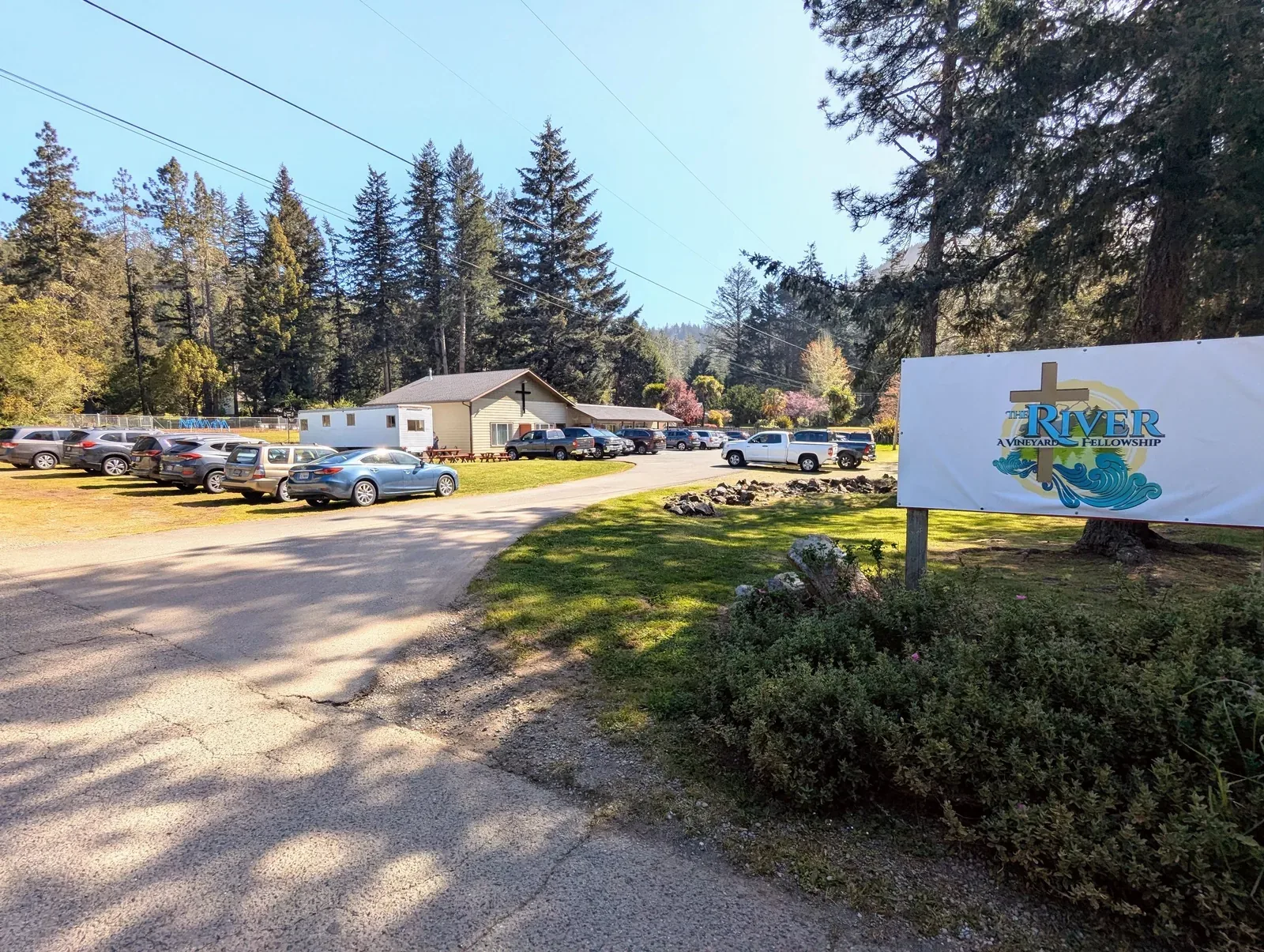 The River church building and roadside sign on Sunkist Lane in Hiouchi